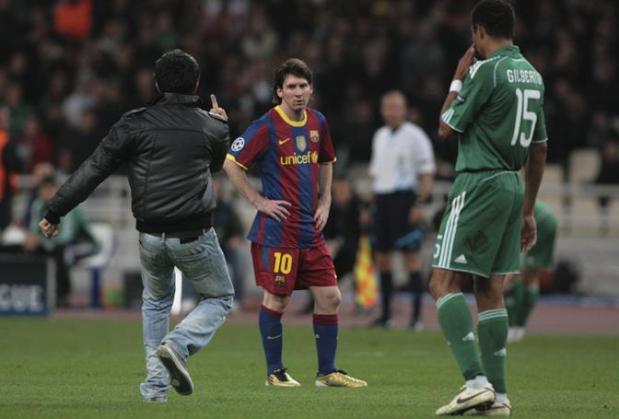 An unidentified Panathinaikos FC supporter makes an obscene gesture to Lionel Messi of FC Barcelona in the second half of the Champions League Group D soccer match at Olympic stadium in Athens